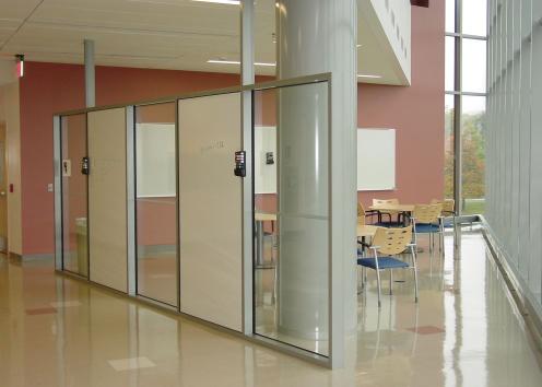 collaboration area with tables and whiteboards